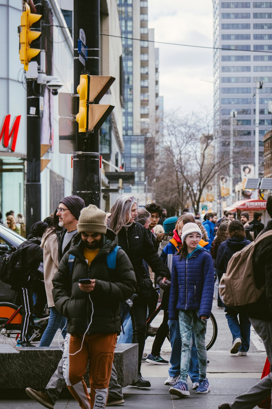 Busy Toronto street market with people walking in autumn