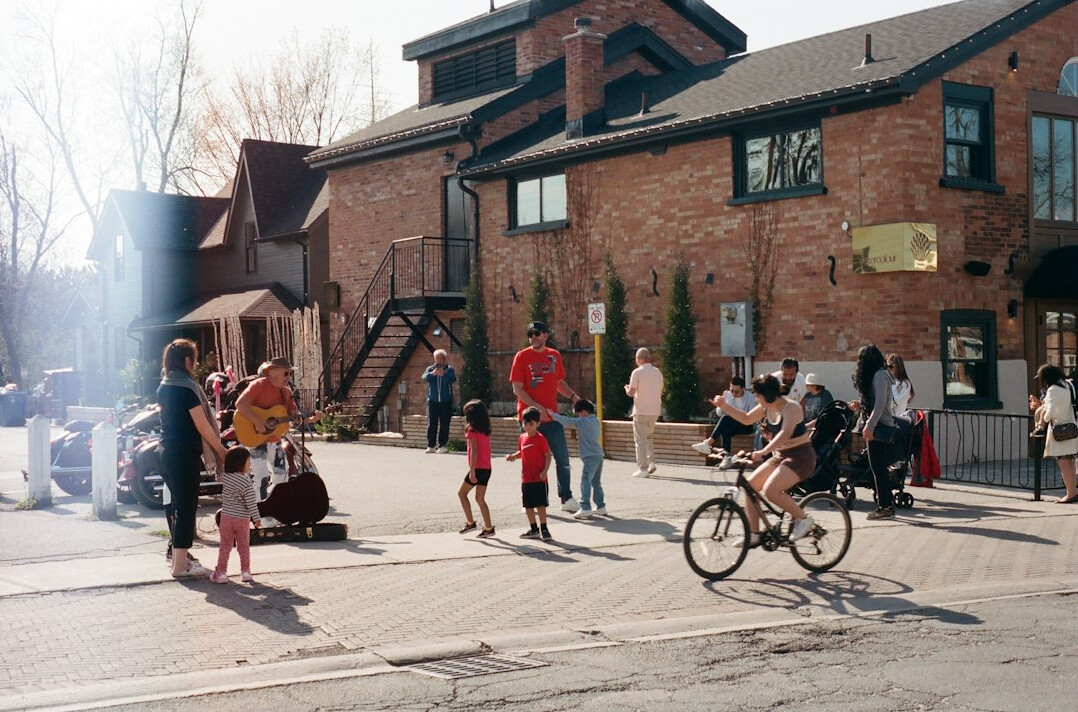 Diverse group of people laughing together at a Canadian street festival
