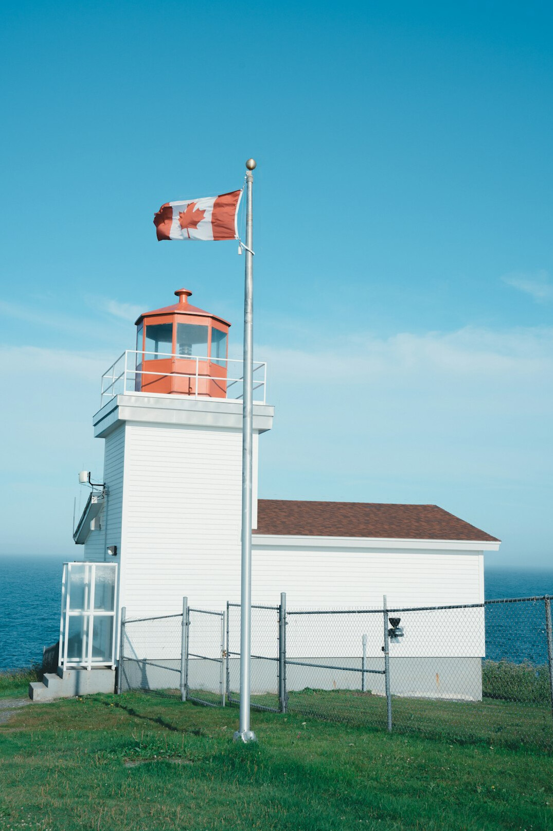 Lighthouse on a foggy Canadian maritime coastline in the morning